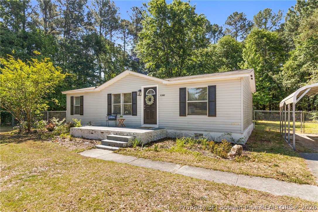 6568 Sandy Creek Road Stedman, NC 28391 - Photo 3 of 34 a front view of a house with a yard