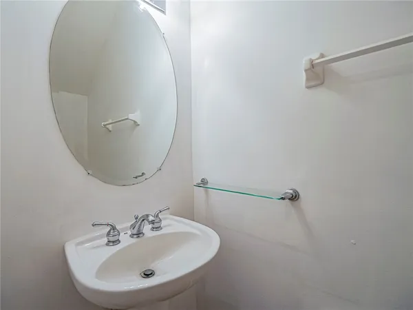 a bathroom with a sink and mirror