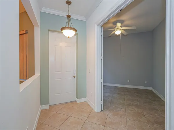 a view of a chandelier fan and kitchen view