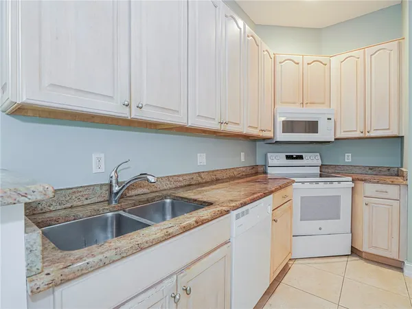 a kitchen with stainless steel appliances granite countertop a sink and dishwasher