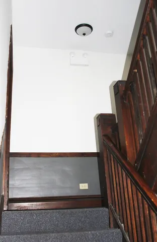 a view of staircase with wooden floor and furniture