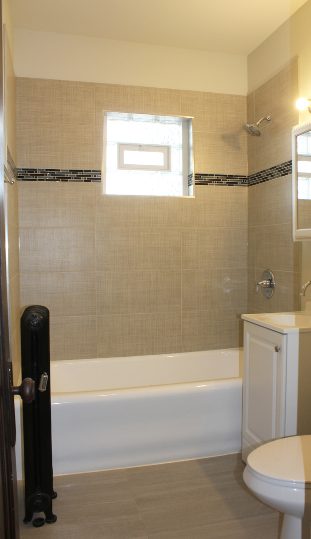 6 West 111th Place Chicago, IL 60628 - Photo 7 of 18 a bathroom with a shower and a bathtub