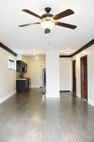 a view of a kitchen with a sink and a refrigerator