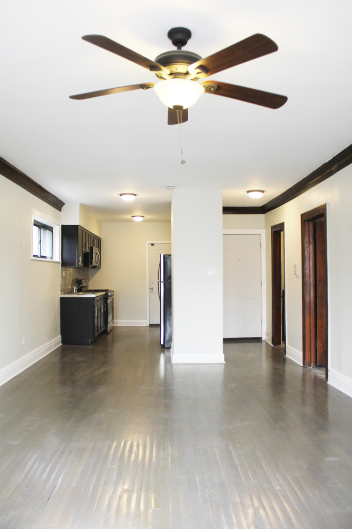6 West 111th Place Chicago, IL 60628 - Photo 8 of 18 a view of a kitchen with a sink and a refrigerator