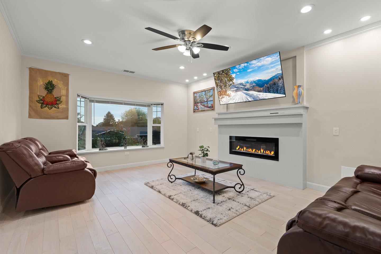 1011 Prospect Heights Santa Cruz, CA 95065 - Photo 23 of 50 a living room with furniture a fireplace and a flat screen tv