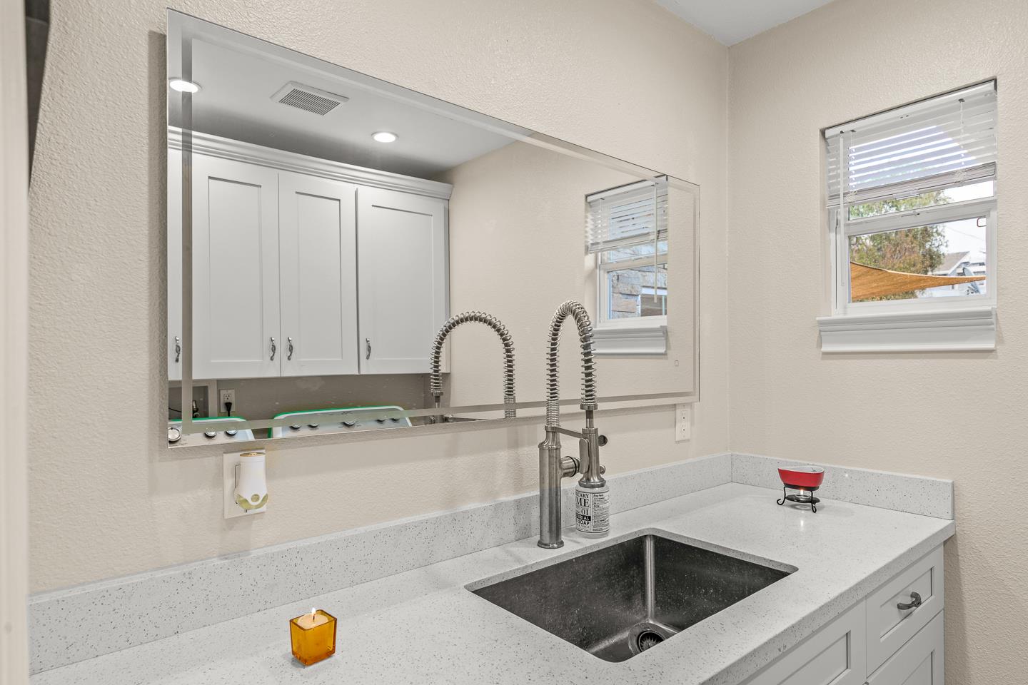 1011 Prospect Heights Santa Cruz, CA 95065 - Photo 42 of 50 a kitchen with a sink and a stove with white cabinets