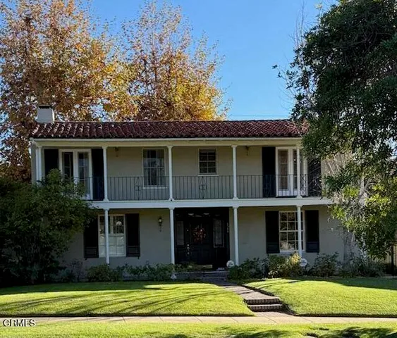 a view of a livingroom with wooden floor and staircase