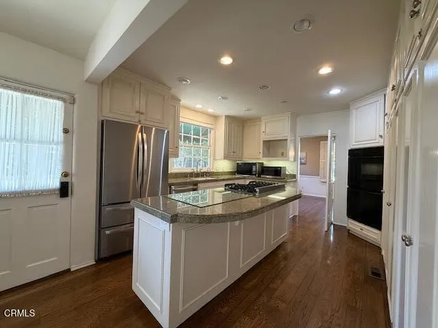 a living room with furniture window and wooden floor