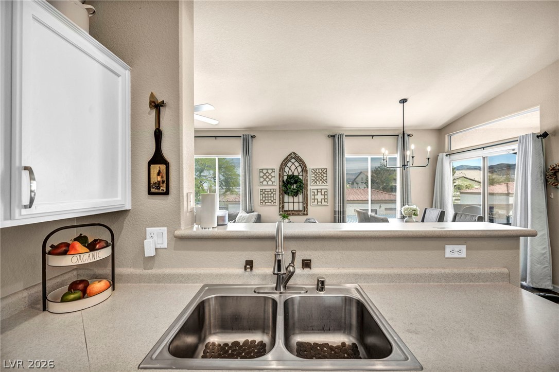 2305 West Horizon Ridge Parkway, Unit 3621 Henderson, NV 89052 - Photo 7 of 23 A well-equipped kitchen features a dual-basin sink and an open view to the adjacent dining space with vaulted ceilings.