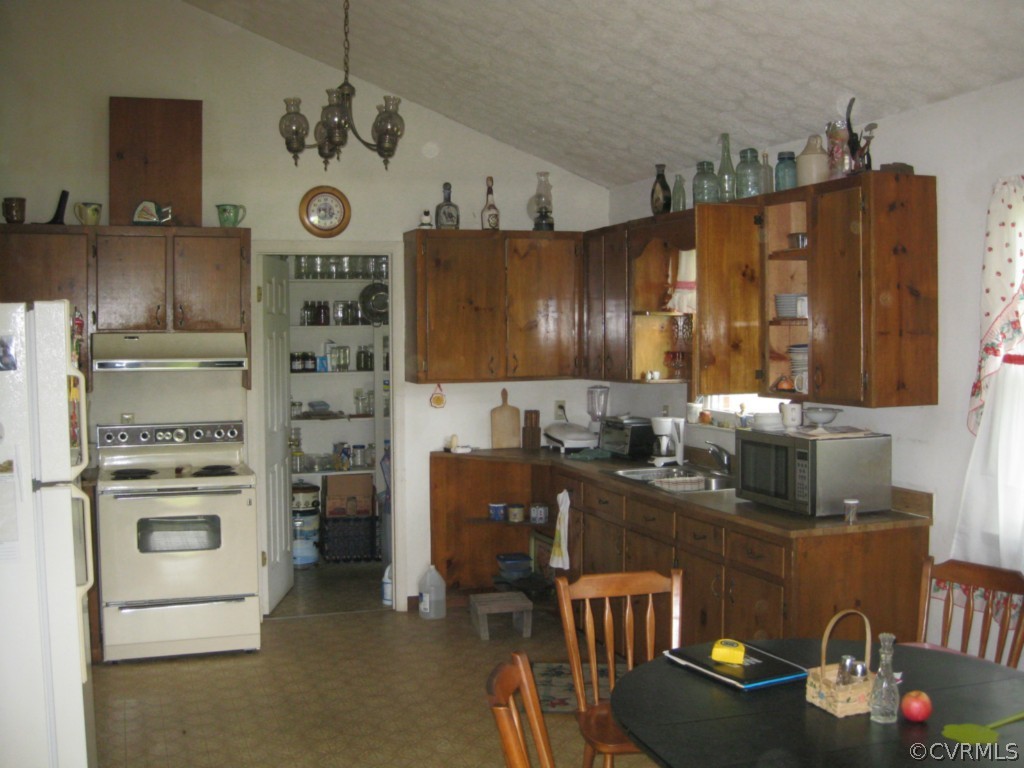 1067 Unity Road Kenbridge, VA 23944 - Photo 13 of 21 a kitchen with a refrigerator and a stove top oven