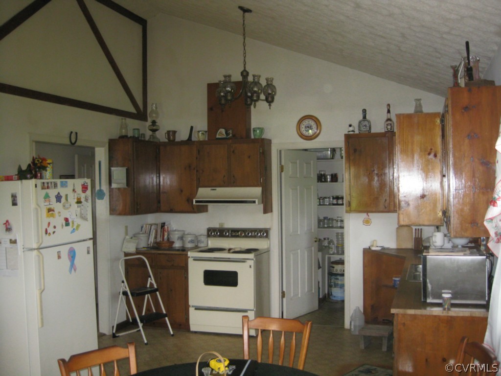 1067 Unity Road Kenbridge, VA 23944 - Photo 14 of 21 a kitchen with stainless steel appliances granite countertop a refrigerator a oven a stove and a dining table with wooden floor