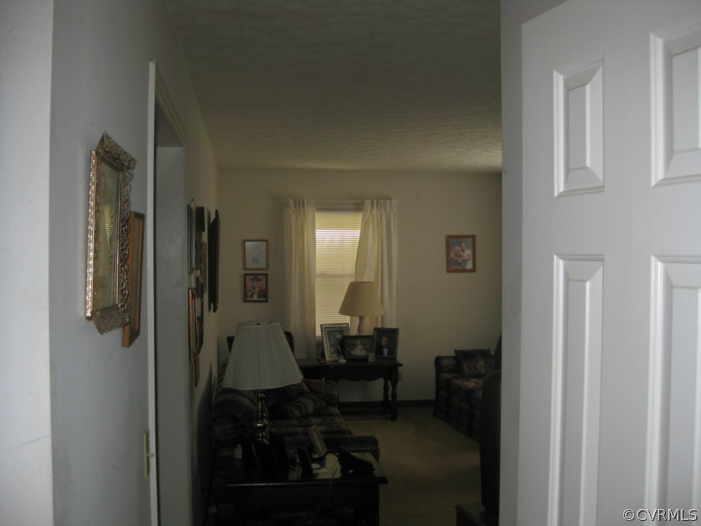 1067 Unity Road Kenbridge, VA 23944 - Photo 20 of 21 a view of a hallway with wooden floor windows and a bathroom