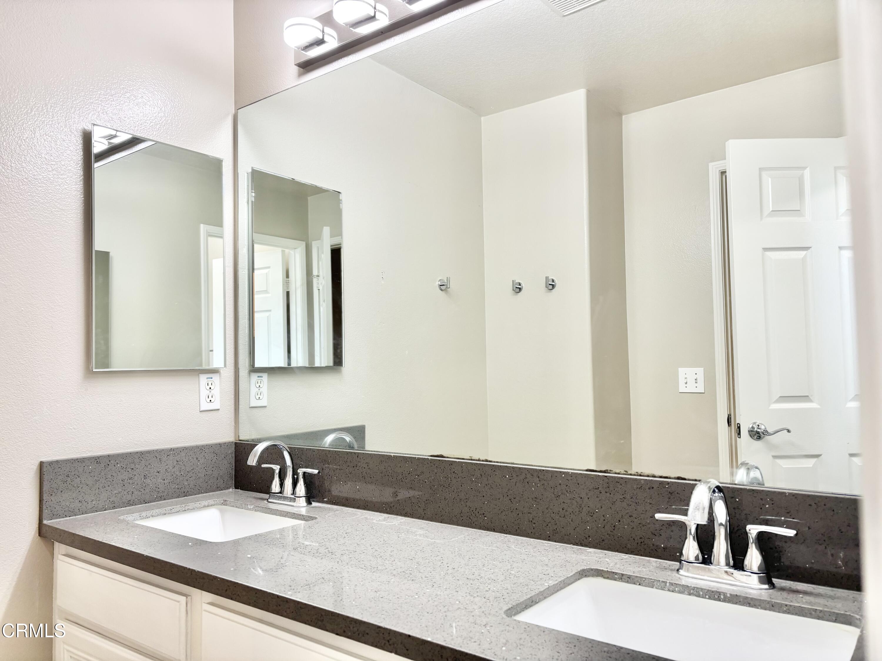 818 Navigator Way Oxnard, CA 93035 - Photo 12 of 29 a bathroom with a sink and a mirror