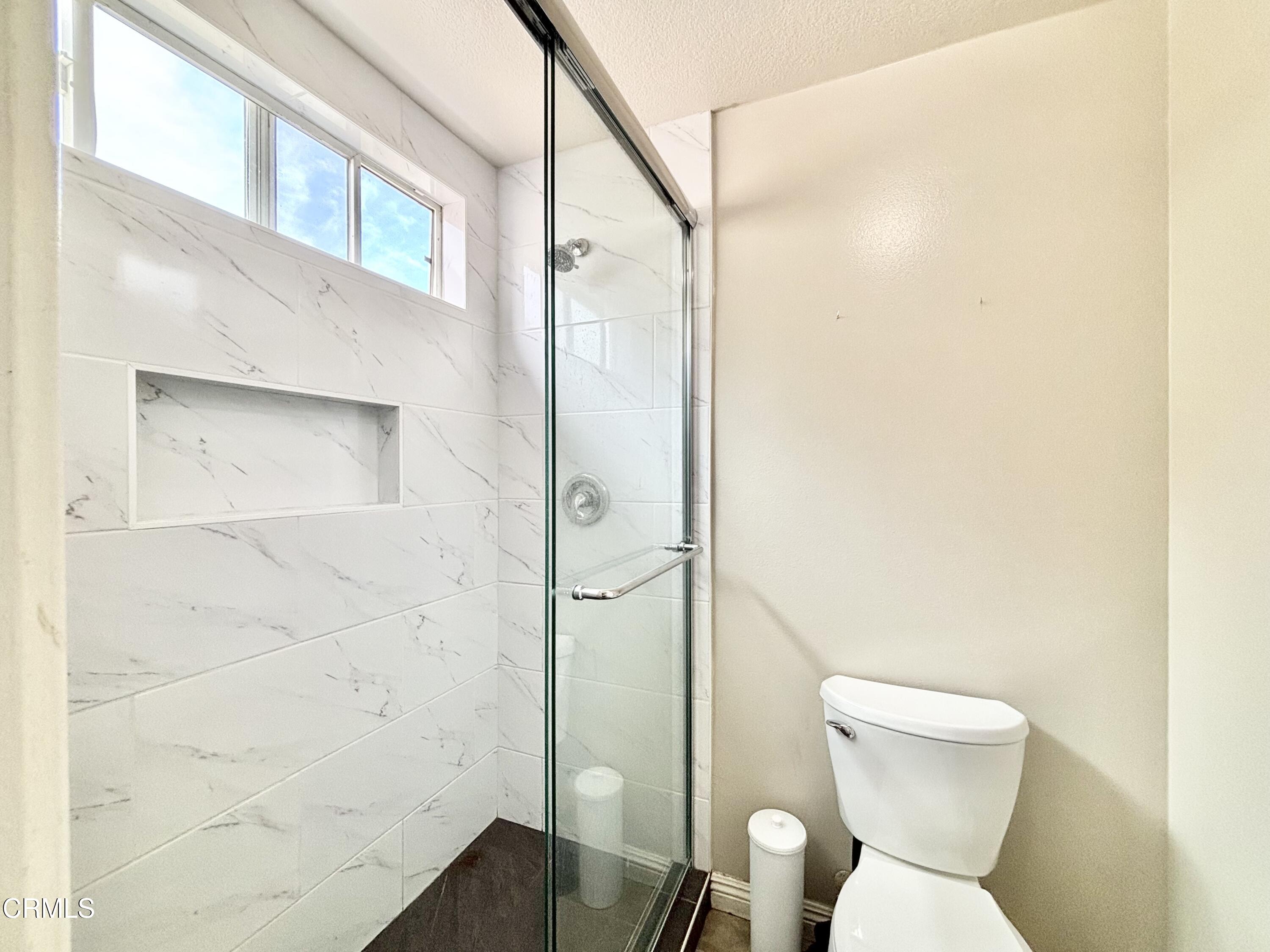 818 Navigator Way Oxnard, CA 93035 - Photo 13 of 29 a bathroom with a toilet and a shower