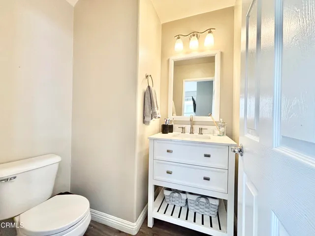 a bathroom with a sink vanity mirror and toilet