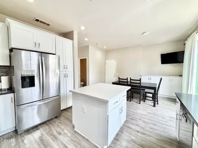 a kitchen with stainless steel appliances a refrigerator a stove a sink and a refrigerator