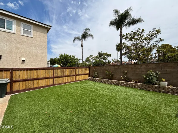 a backyard of a house with lots of green space and lake view