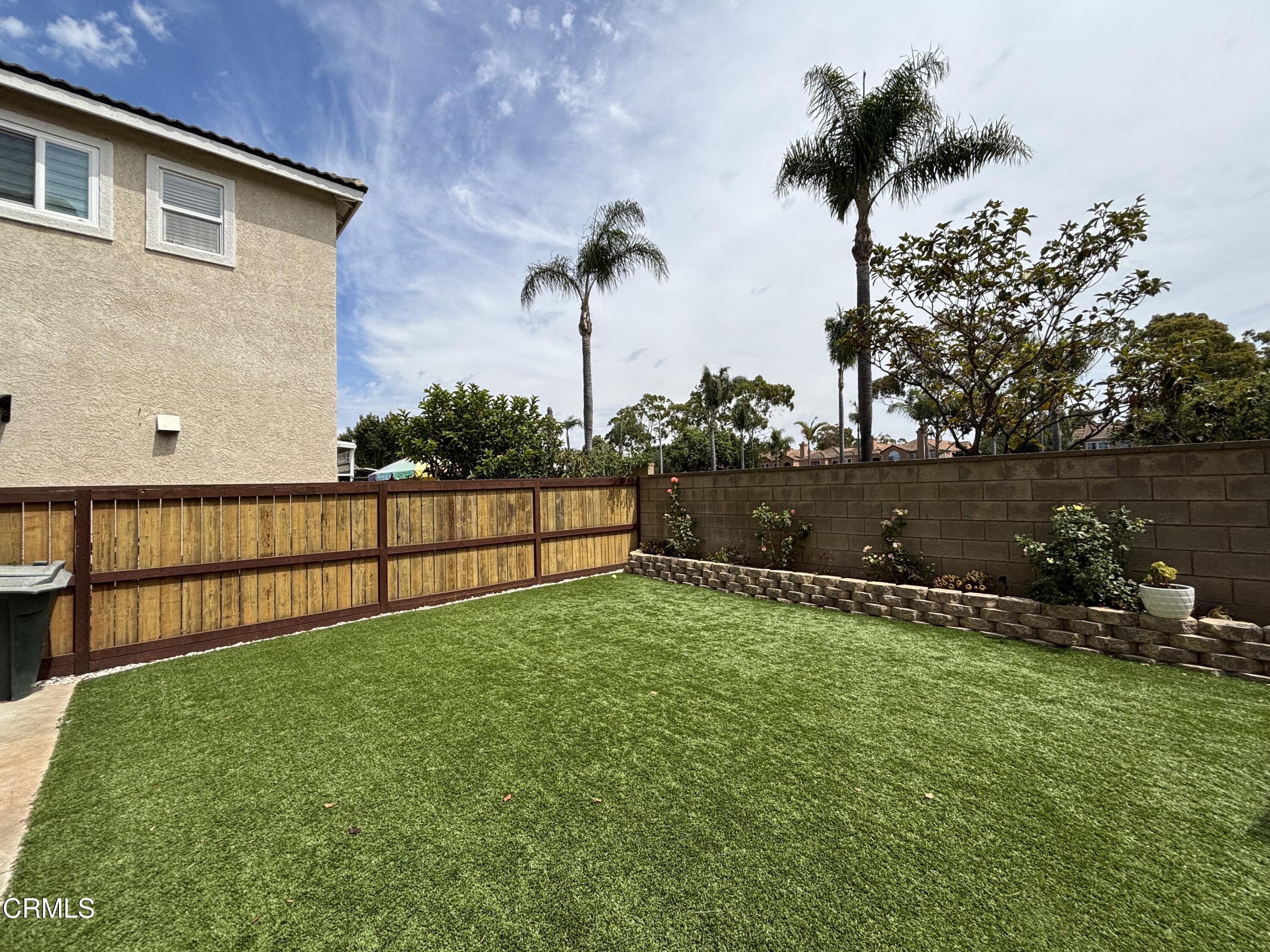 818 Navigator Way Oxnard, CA 93035 - Photo 28 of 29 a backyard of a house with lots of green space and lake view