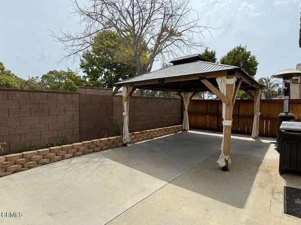 a backyard with wooden fence and a fountain