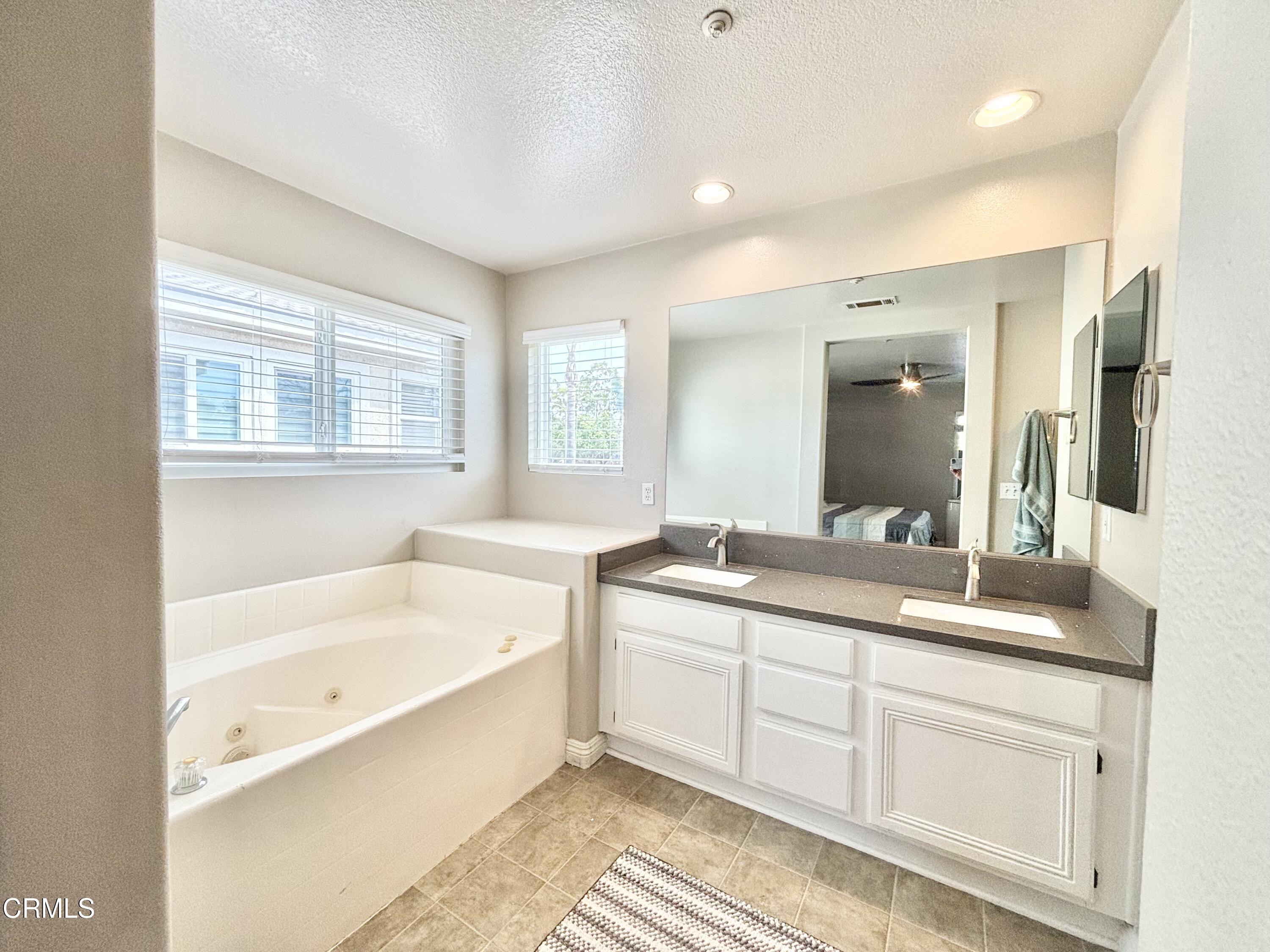 818 Navigator Way Oxnard, CA 93035 - Photo 6 of 29 a bathroom with a tub sink and mirror