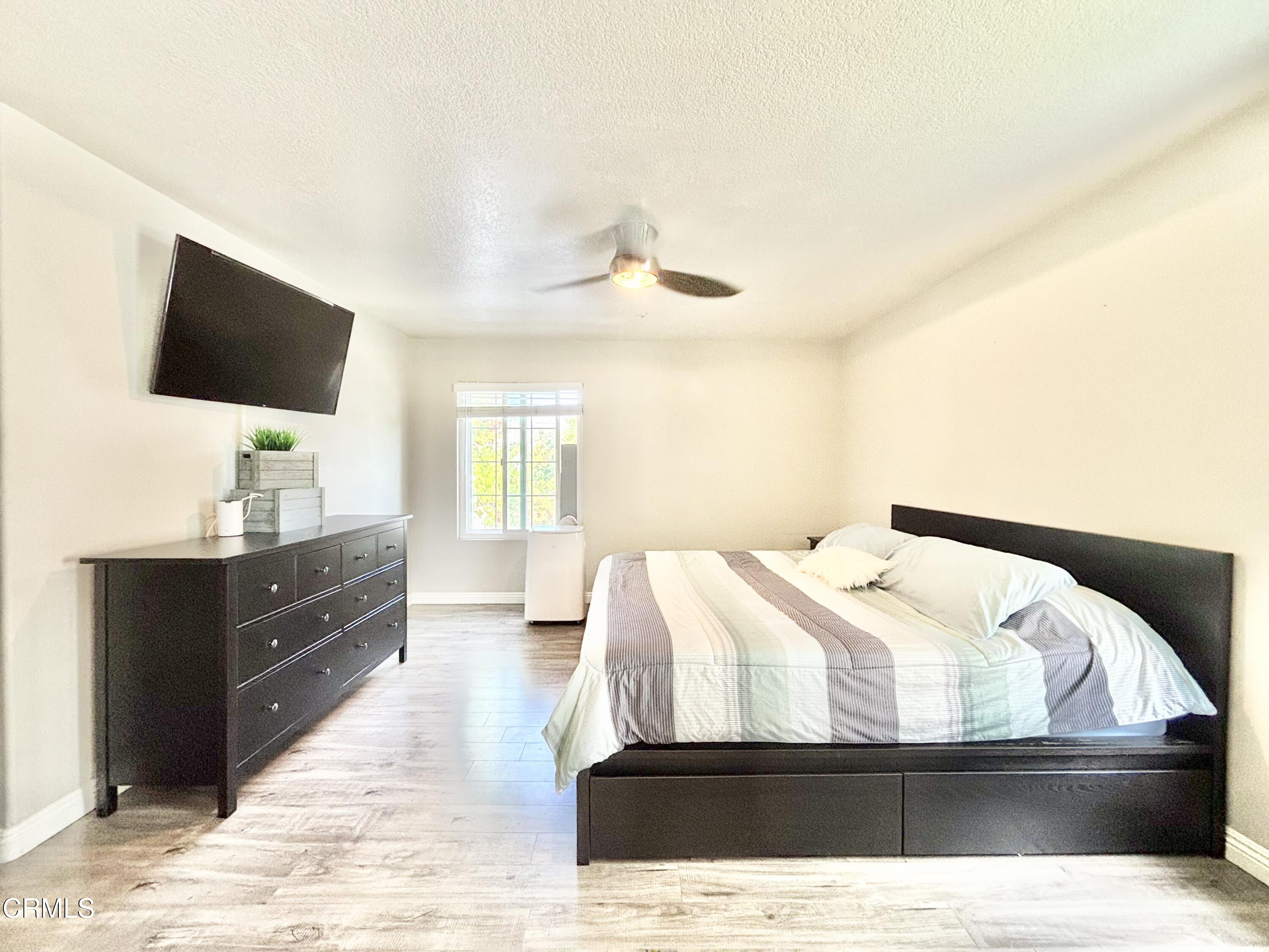 818 Navigator Way Oxnard, CA 93035 - Photo 8 of 29 a bedroom with a bed and a flat screen tv