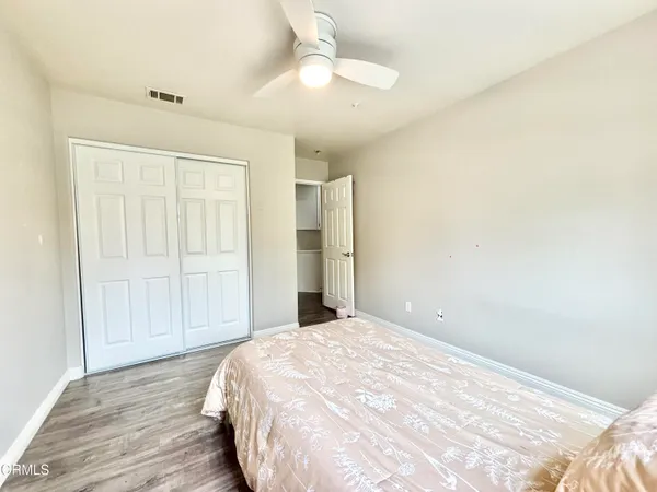 a view of a livingroom with wooden floor and closet