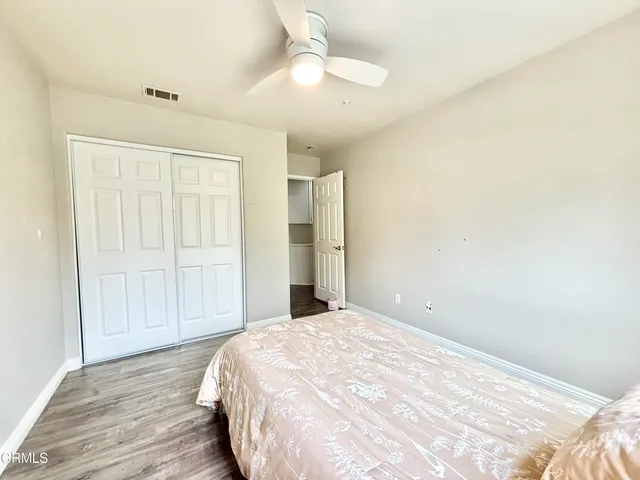 a view of a livingroom with wooden floor and closet