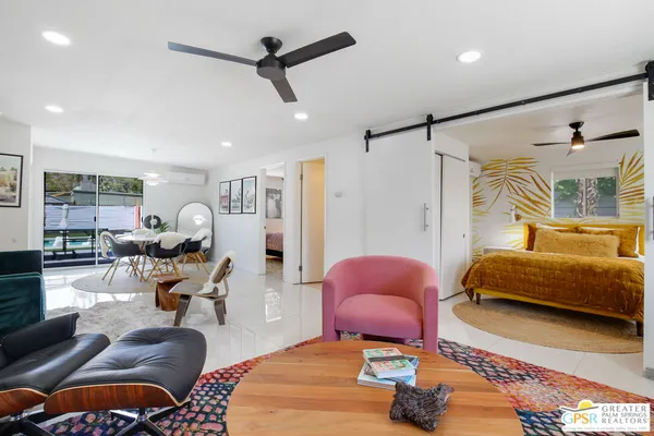 a bedroom with furniture and a chair