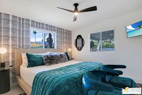 a bedroom with a bed and window