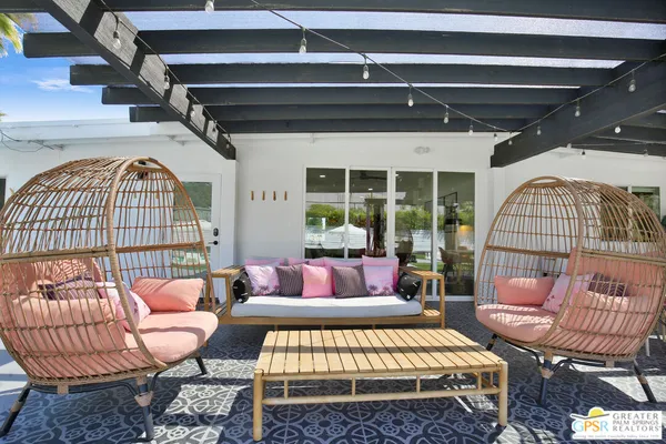 a outdoor living space with furniture and a rug