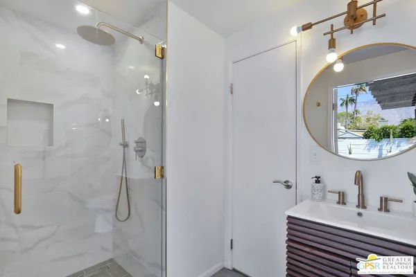 a bathroom with a sink mirror and vanity