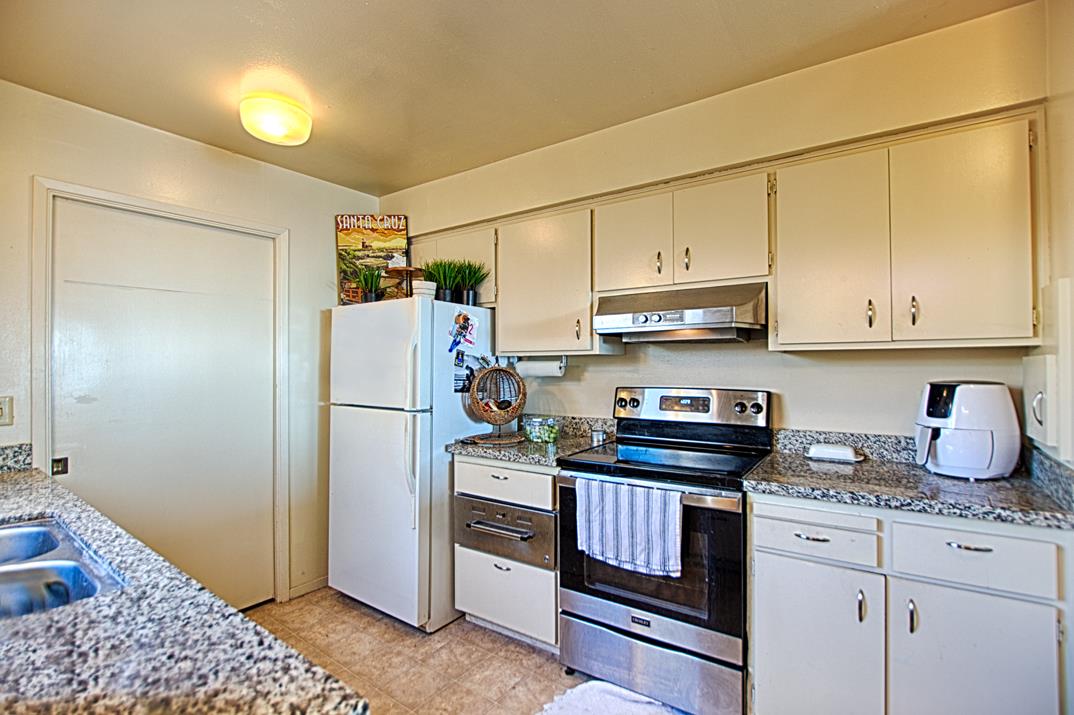 369 Sea Ridge Road Aptos, CA 95003 - Photo 11 of 20 a kitchen with stainless steel appliances granite countertop a refrigerator stove and sink