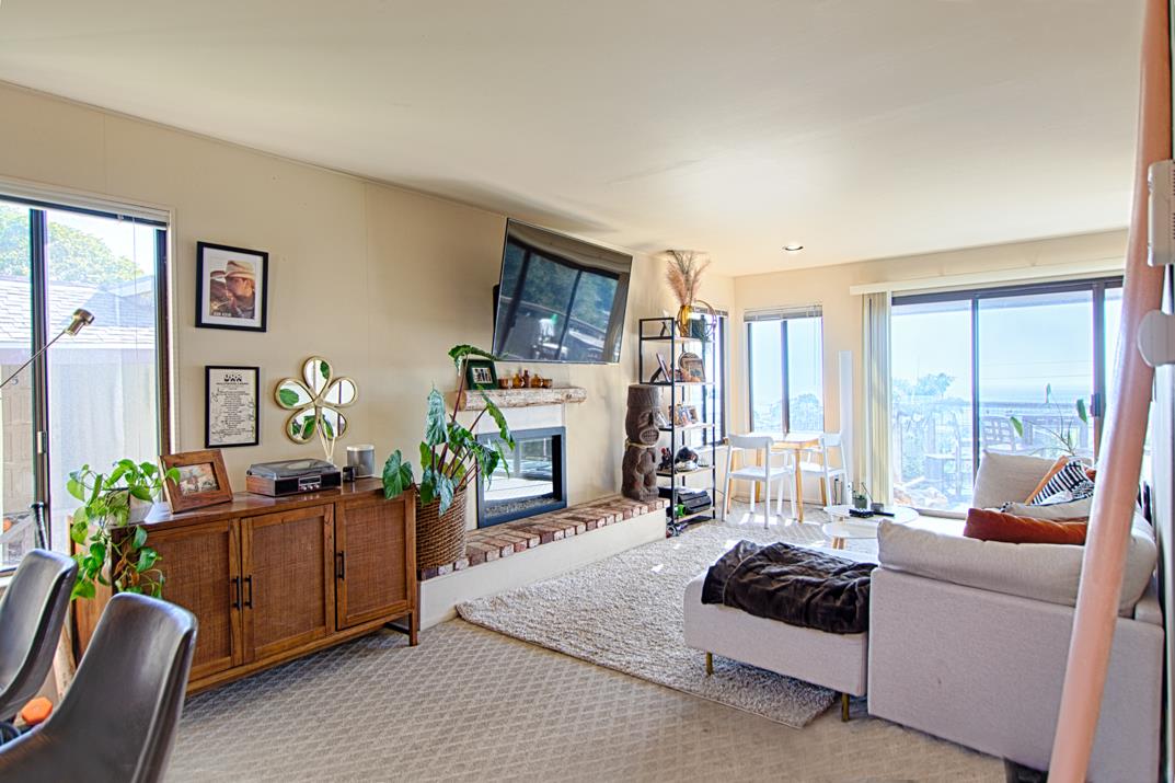 369 Sea Ridge Road Aptos, CA 95003 - Photo 12 of 20 a living room with furniture fireplace and a large window