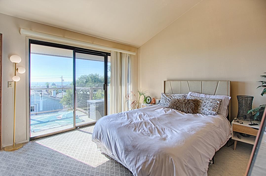369 Sea Ridge Road Aptos, CA 95003 - Photo 16 of 20 a bedroom with a large bed and a large window