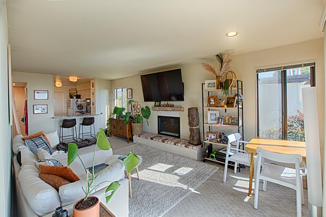 369 Sea Ridge Road Aptos, CA 95003 - Photo 9 of 20 a living room with furniture a flat screen tv and a fireplace