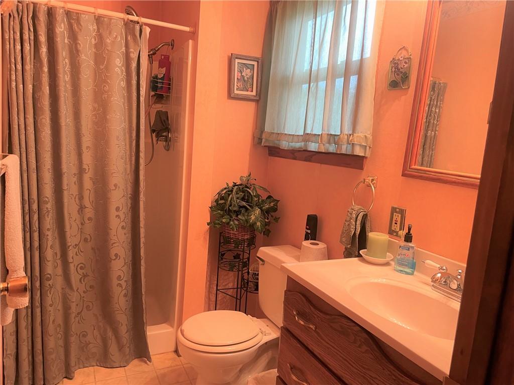 1606 Atkinson Street New Castle, PA 16101 - Photo 11 of 15 a bathroom with a sink a toilet and shower curtain
