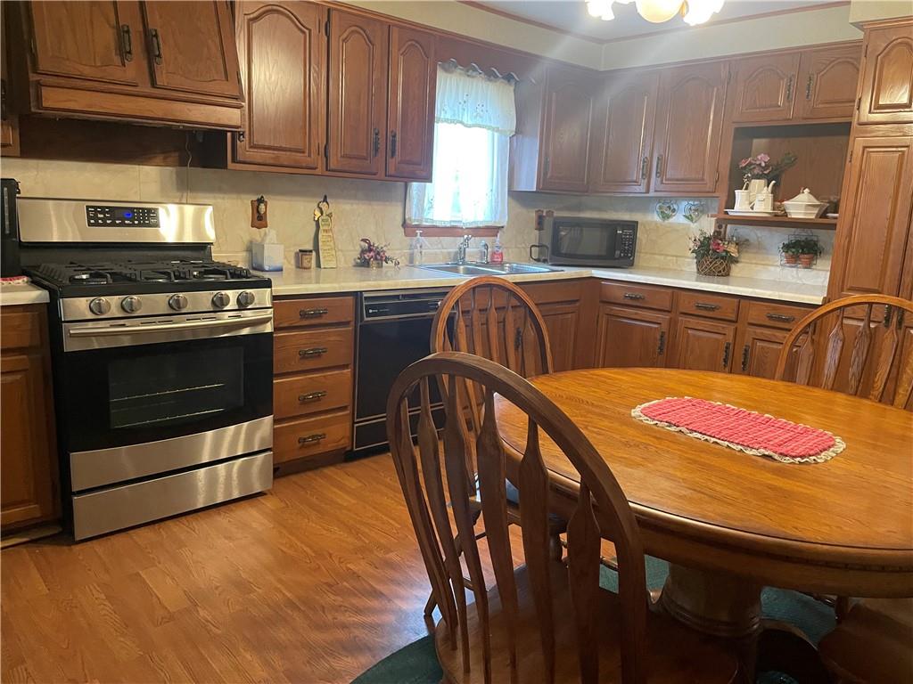 1606 Atkinson Street New Castle, PA 16101 - Photo 3 of 15 a kitchen with stainless steel appliances granite countertop a stove a sink and a refrigerator