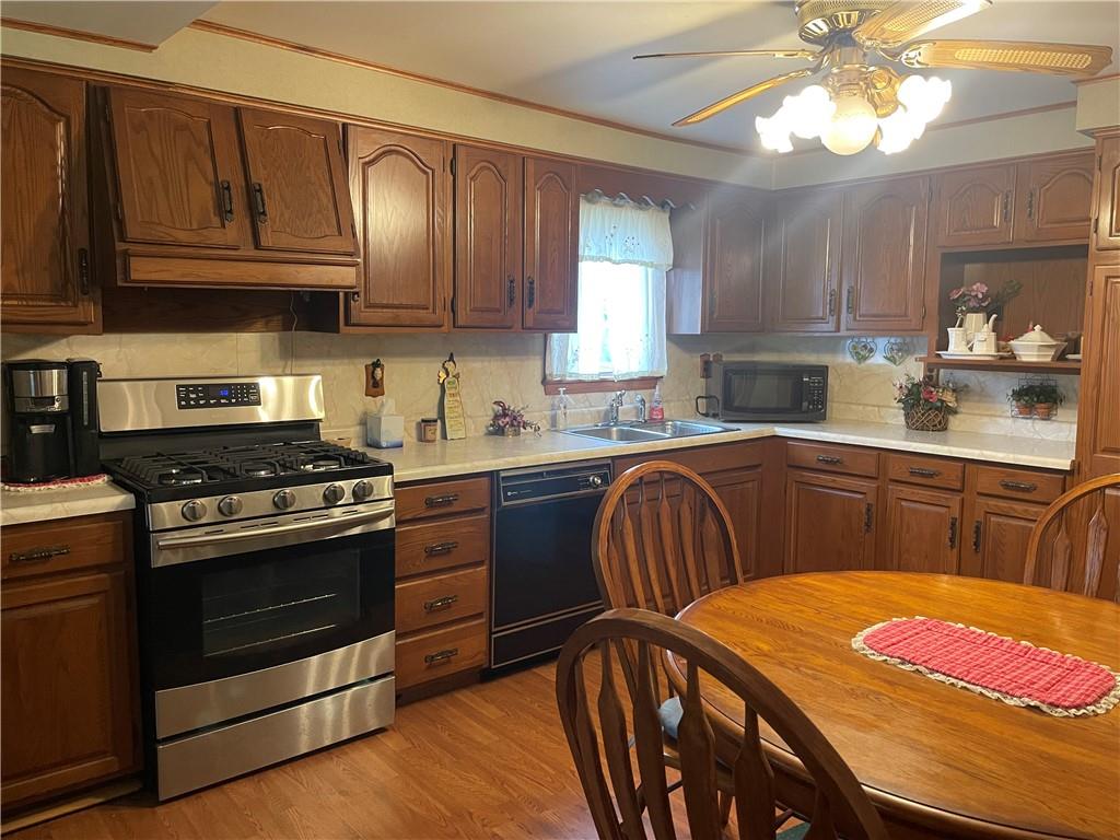 1606 Atkinson Street New Castle, PA 16101 - Photo 4 of 15 a kitchen with stainless steel appliances granite countertop a stove a sink dishwasher and cabinets with wooden floor