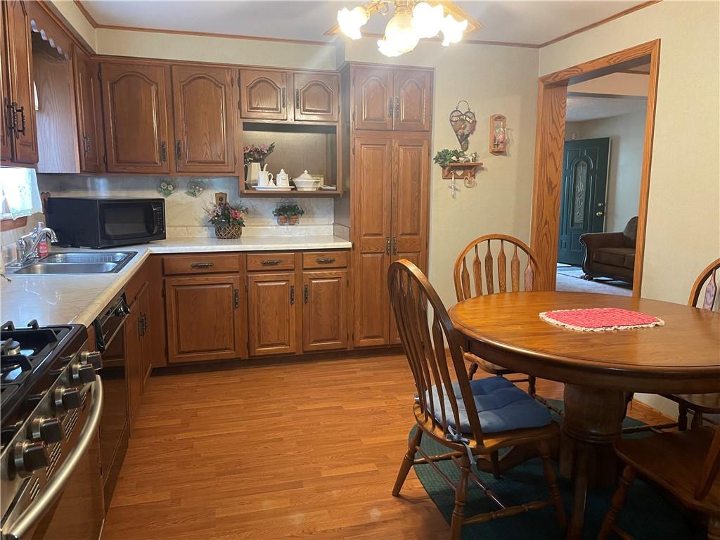1606 Atkinson Street New Castle, PA 16101 - Photo 5 of 15 a kitchen with stainless steel appliances granite countertop a sink table and chairs