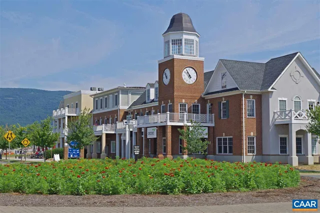 a front view of a building with a garden and plants