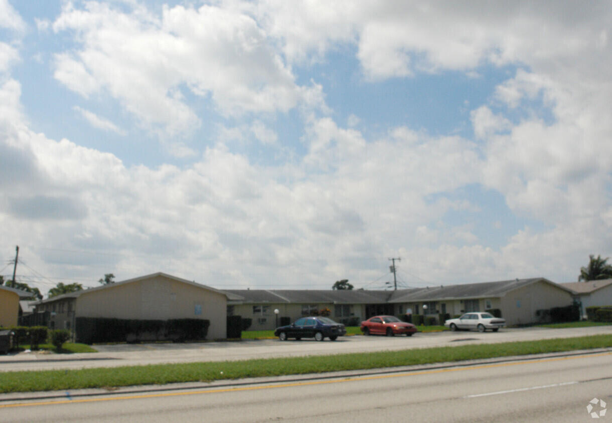 7624 Pembroke Road, Unit C Miramar, FL 33023 - Photo 1 of 13 a view of building with cars parked