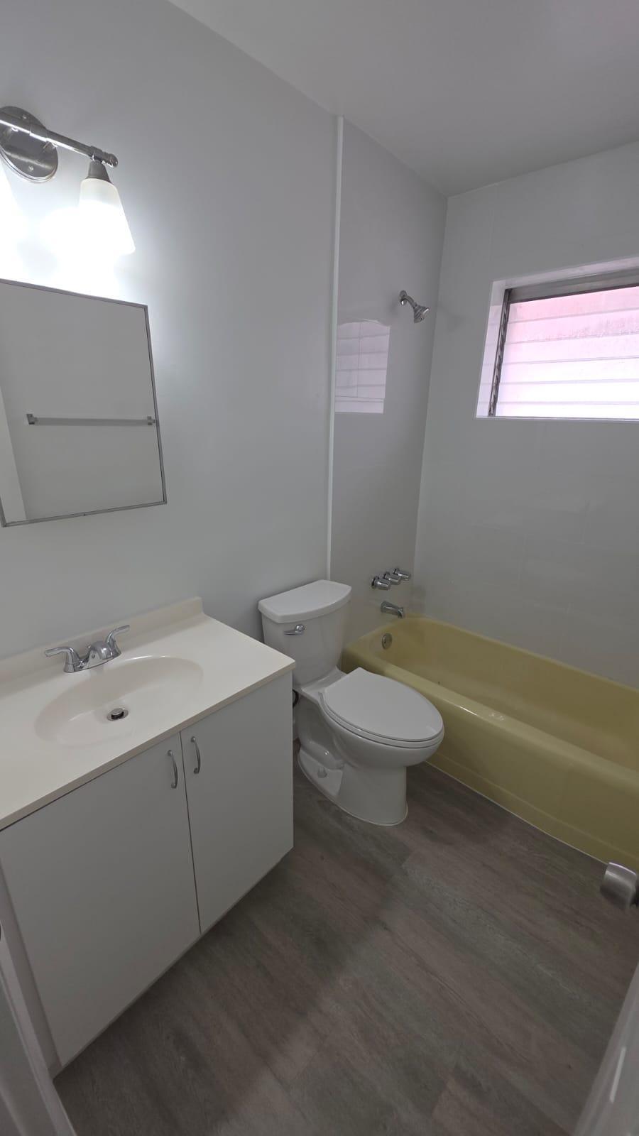7624 Pembroke Road, Unit C Miramar, FL 33023 - Photo 13 of 13 a bathroom with a toilet sink and mirror