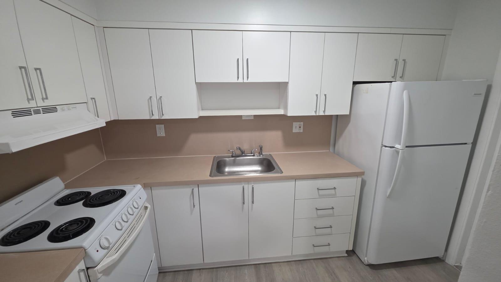 7624 Pembroke Road, Unit C Miramar, FL 33023 - Photo 4 of 13 a kitchen with a refrigerator sink and cabinets