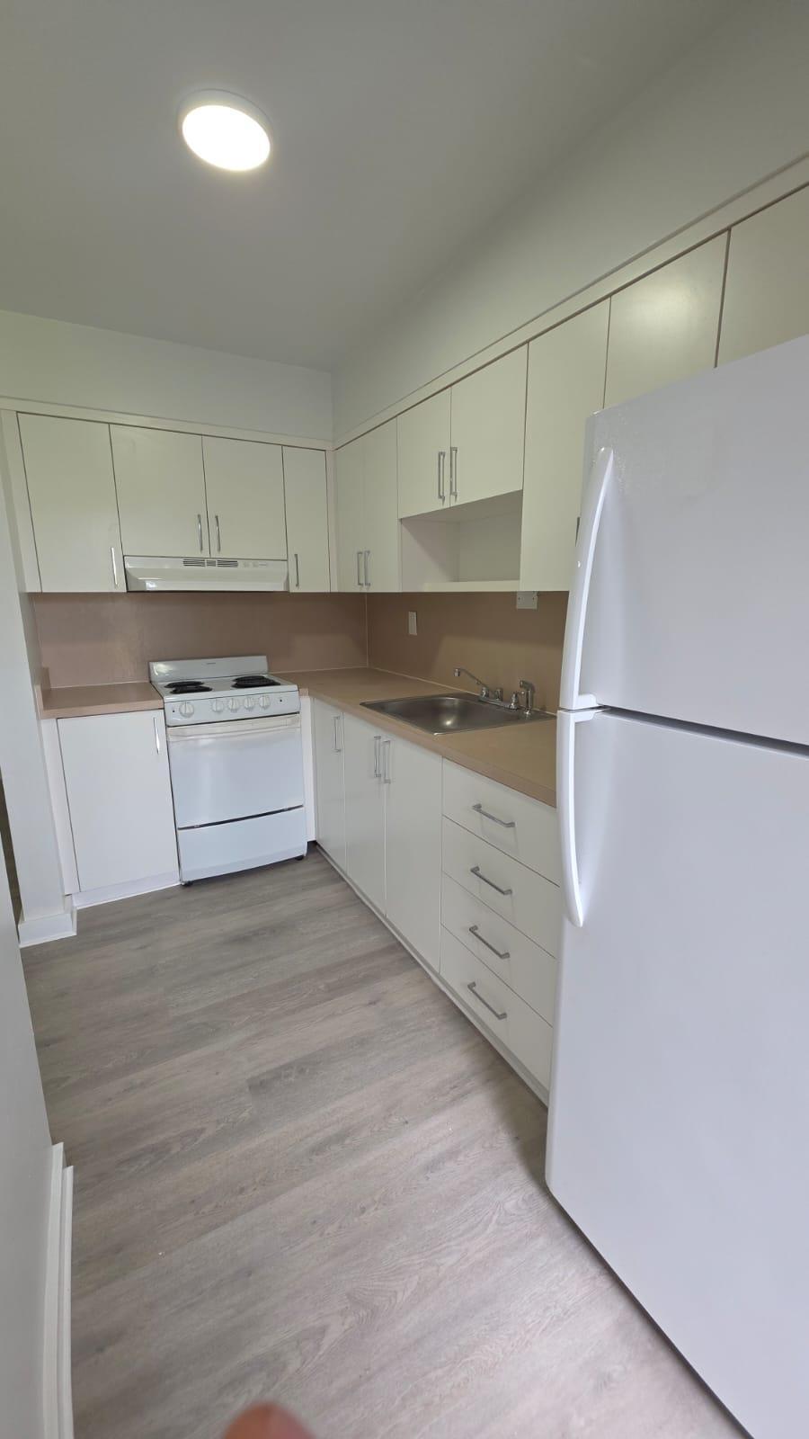 7624 Pembroke Road, Unit C Miramar, FL 33023 - Photo 9 of 13 a kitchen with a refrigerator and a stove top oven