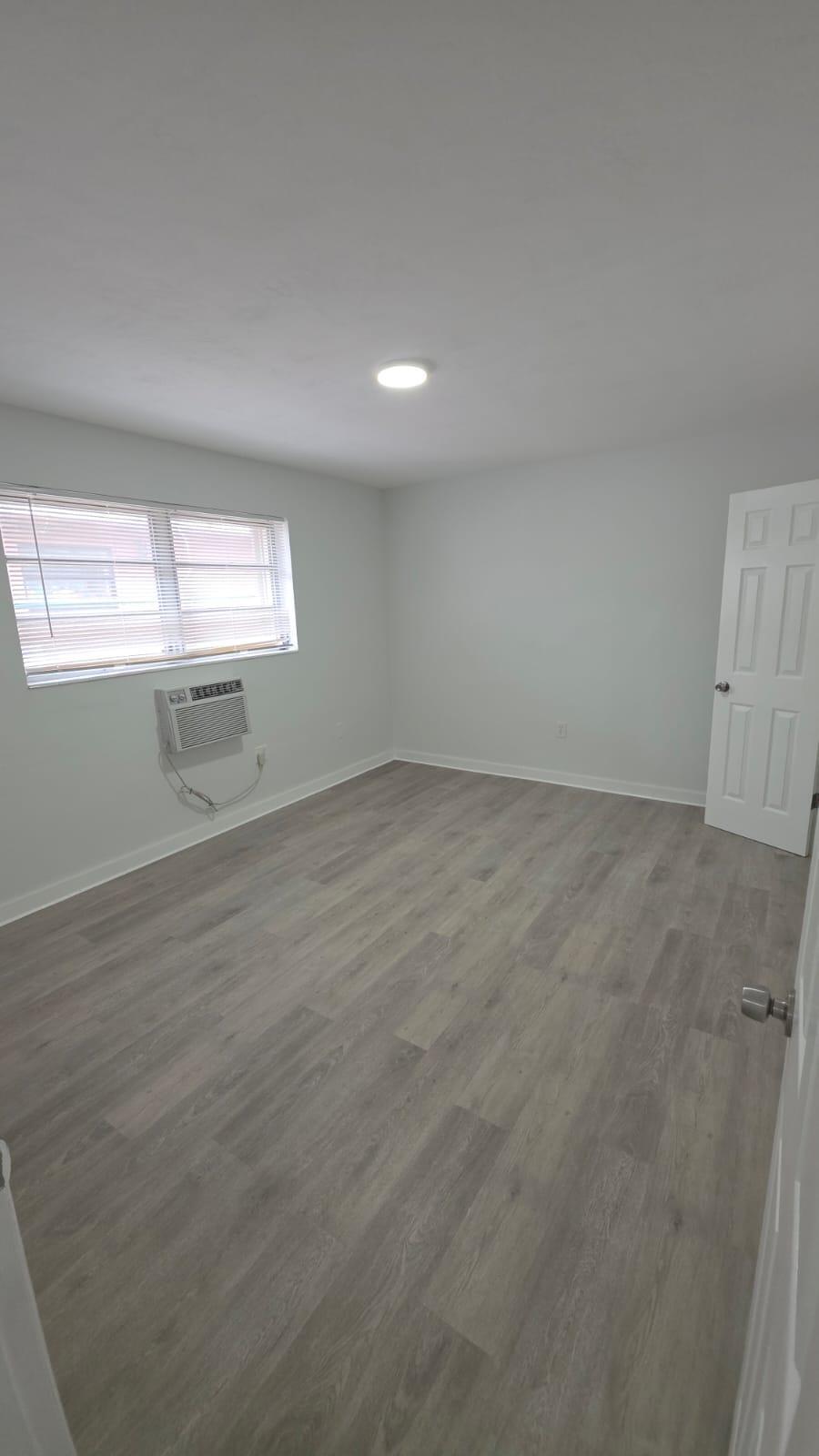 7624 Pembroke Road, Unit C Miramar, FL 33023 - Photo 10 of 13 wooden floor in an empty room with a window
