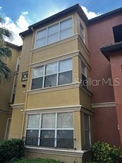 5148 Conroy Road, Unit 18 Orlando, FL 32811 - Photo 1 of 30 a tall building next to a yard