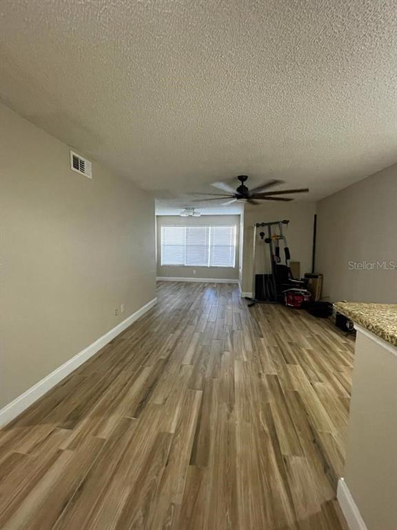 5148 Conroy Road, Unit 18 Orlando, FL 32811 - Photo 12 of 30 a view of empty room with wooden floor and fan