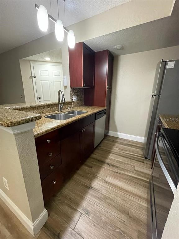 5148 Conroy Road, Unit 18 Orlando, FL 32811 - Photo 21 of 30 a kitchen with a sink and a refrigerator