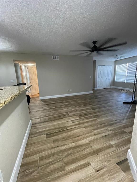 5148 Conroy Road, Unit 18 Orlando, FL 32811 - Photo 4 of 30 a view of a livingroom with wooden floor