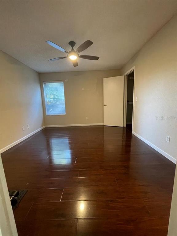 5148 Conroy Road, Unit 18 Orlando, FL 32811 - Photo 6 of 30 an empty room with wooden floor and windows